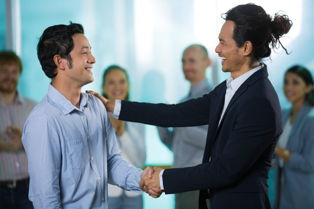 boss congratulating new employee.