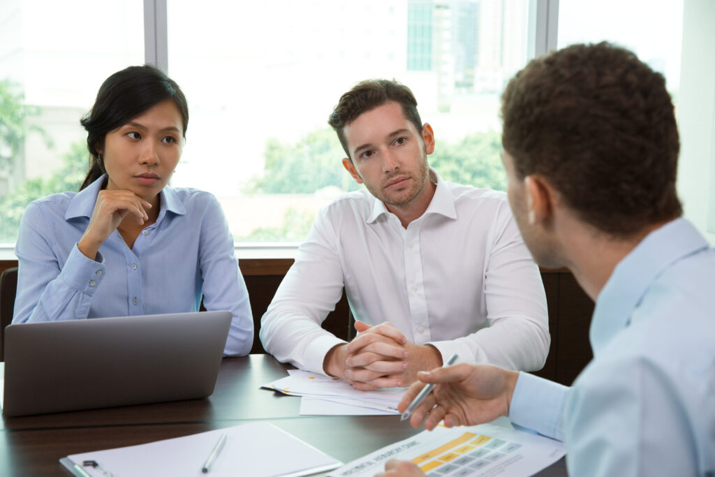 Business team discussing communication strategies during a meeting about using technology to optimize leave management.