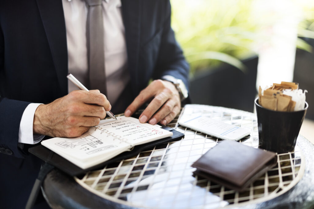 Businessman setting clear objectives by taking notes.