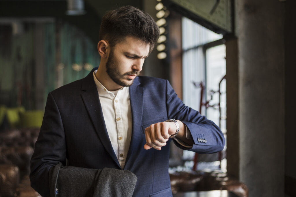 Businessman checking his watch, representing reduced processing time with automated claims