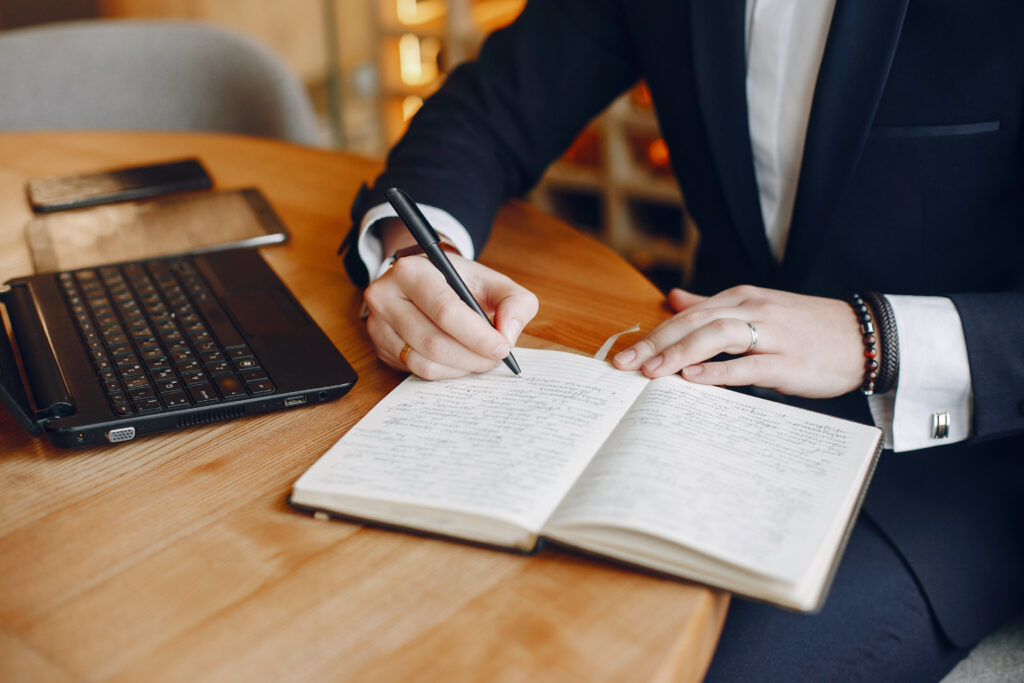 Businessman taking notes while working on payroll compliance in Malaysia