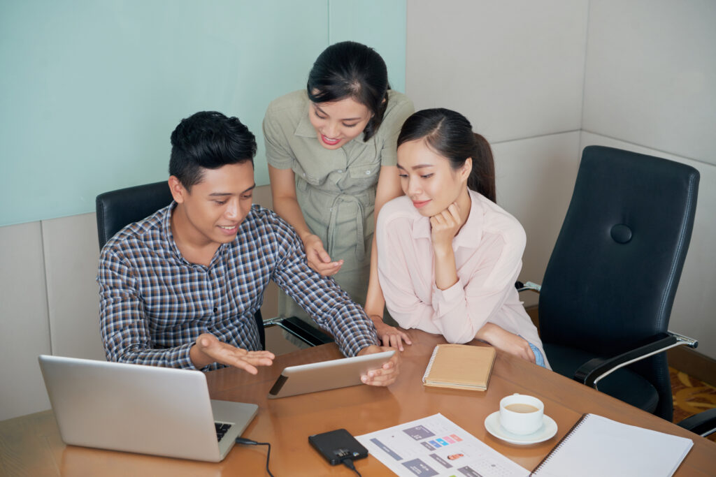 Colleagues discussing strata management tasks together in the office.