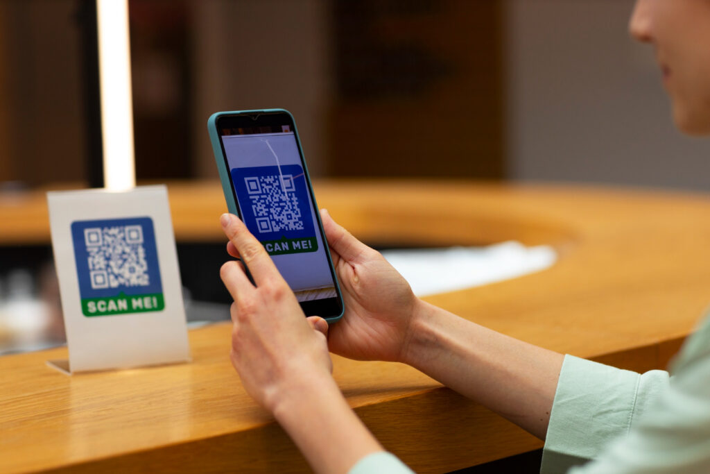 Close-up of a smartphone scanning a QR code for e-payments in residential communities.