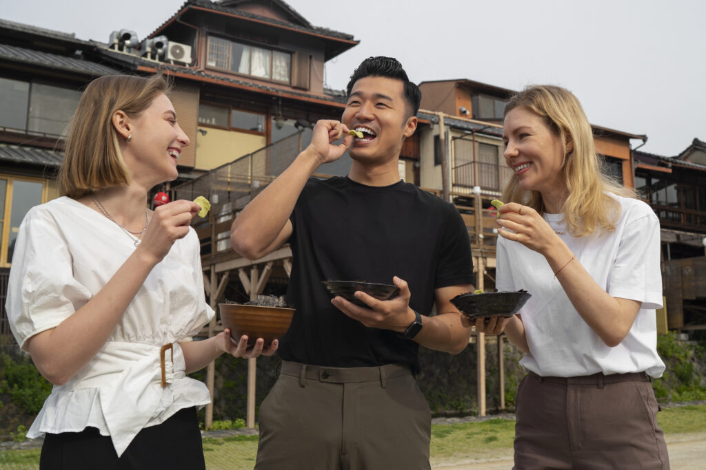 People enjoying snacks together outdoors, symbolizing community harmony.