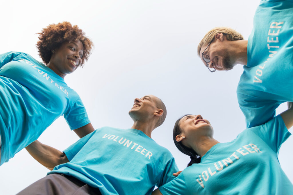 Volunteers Smiling and Bonding at a Community Event