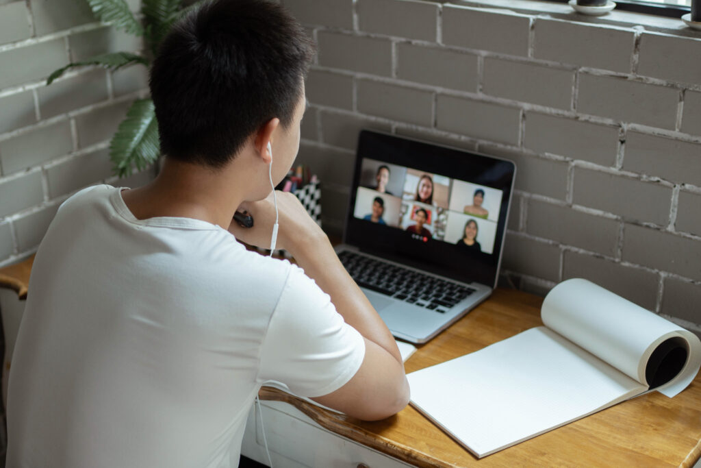 Employee participating in a remote meeting to discuss cross-border payroll challenges in a hybrid work environment.