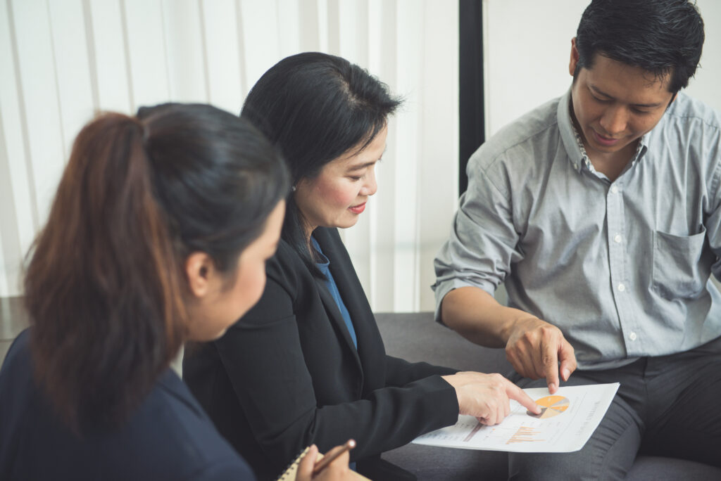 A team of professionals discussing financial documents, showcasing stakeholder involvement in Financial Reporting in Residential Areas.